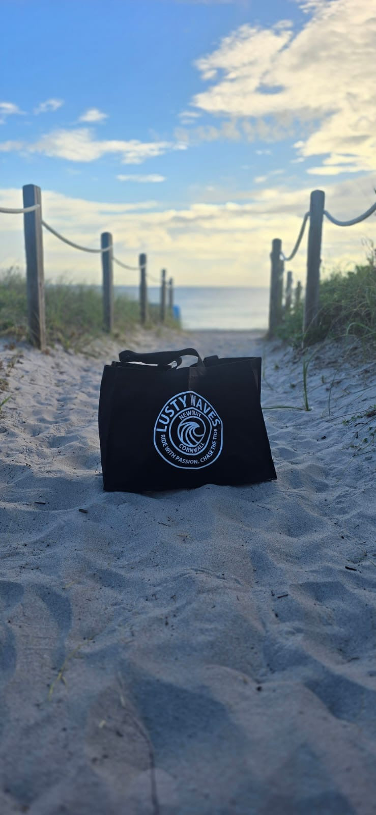 Black bag with a logo on a sandy beach