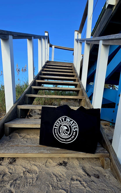 Black bag with a logo on a wooden staircase at the beach